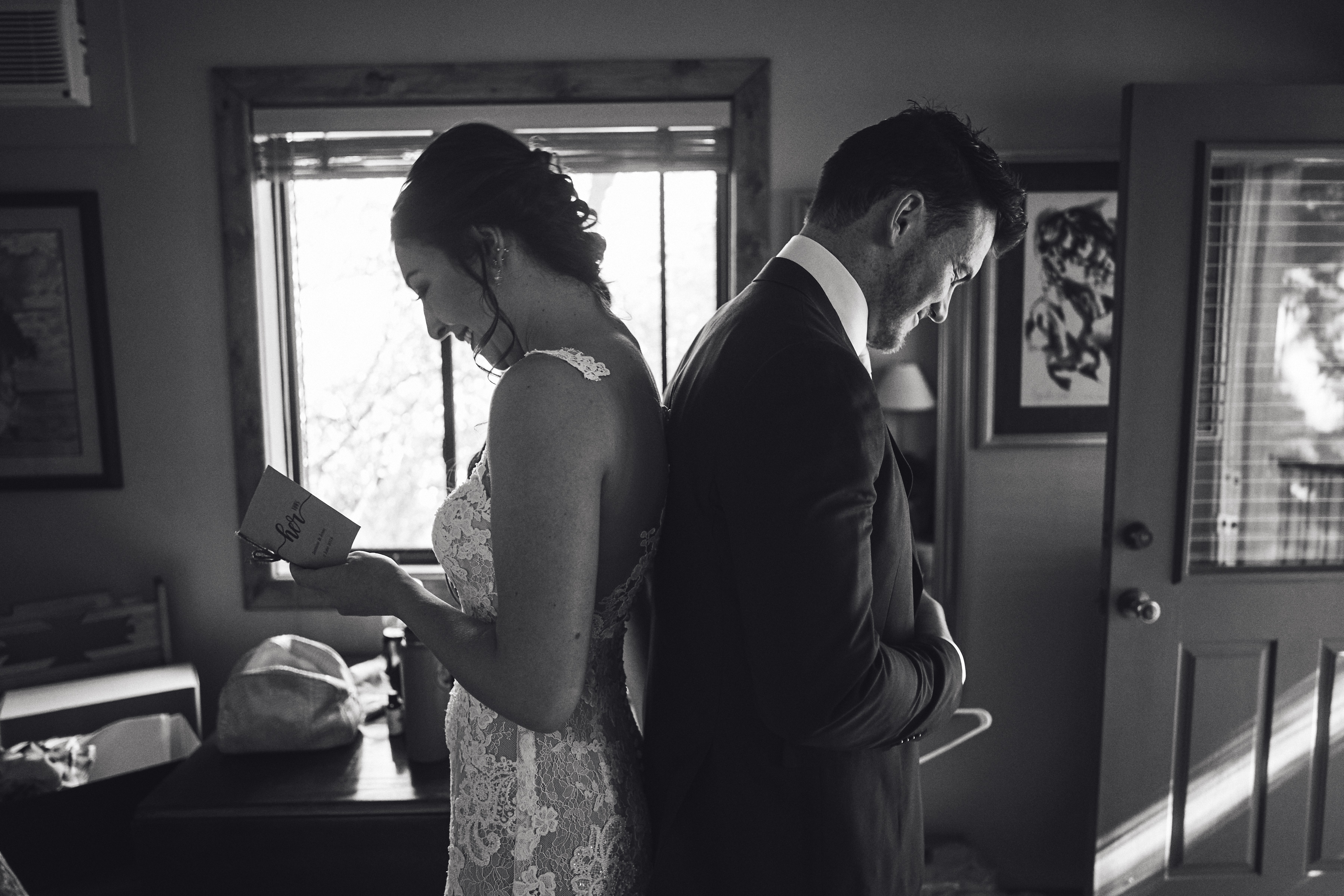 bride and groom reading a letter to one another